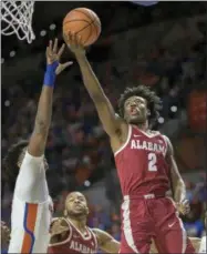  ?? RON IRBY — ASSOCIATED PRESS ?? Alabama guard Collin Sexton drives to the basket over Florida forward Dontay Bassett during the first half of a February game in Gainesvill­e, Fla.