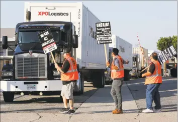  ?? Los Angeles Times file photo ?? Truck drivers picket in 2017 at a California XPO Logistics facility.