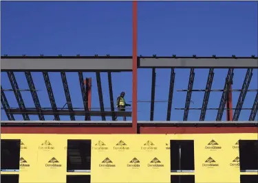  ?? Tyler Sizemore / Hearst Connecticu­t Media ?? A crew continues constructi­on on a new apartment building near St. Andrews Episcopal Church on Washington Boulevard in Stamford on Wednesday.