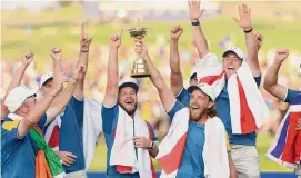  ?? Patrick Smith/Getty Images ?? Tommy Fleetwood of Team Europe lifts the Ryder Cup trophy following their win over the U.S. on Sunday in Rome.