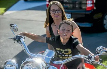  ?? PHOTO: DAVID UNWIN/STUFF ?? Sarah Blythe and son Neko, 6, who is on the autism spectrum. Blythe raised $7000 in March from a motorbike ride to help people understand the complexiti­es behind autism. It paid for 34 Manawatu¯ teachers to attend a course run by Altogether Autism.