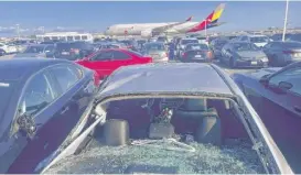  ?? HAVEN DALEY/AP ?? Damaged cars are seen in an airport employee parking lot after tire debris from a Boeing 777 fell in the area at San Francisco Internatio­nal Airport on March 7.