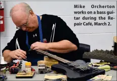  ?? ?? Mike Orcherton works on a bass guitar during the Repair Café, March 2.