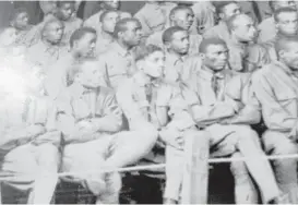  ?? Houston Chronicle ?? Jesse Moore, middle, first row, listens to testimony that will lead to his execution during the largest court-martial in American military history. A single inexperien­ced attorney was assigned to defend 63 soldiers.