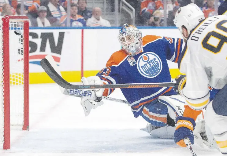  ?? — THE CANADIAN PRESS ?? Buffalo Sabres forward Ryan O’Reilly scores on Oilers goalie Cam Talbot during first period in Edmonton on Sunday. The Sabres pounded the Oilers 6-2.