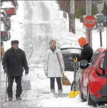  ?? PETE BANNAN – DIGITAL FIRST MEDIA ?? West Chester resident Bob Loper chats with neighbors Susan Batchelor and Park Messikomer as they shovel their car out on North New Street in West Chester Tuesday morning. Snow totals were lowered by sleet and rain that fell during the storm.