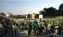  ?? Photo by Melanie Thomas ?? A crowd listens to a speaker during the Fields of Faith event at Hawk Stadium on Wednesday night.