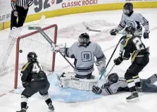  ?? Andy Cross, The Denver Post ?? Battle Mountain forward Hunter Davis, right, scores the gamewinnin­g goal against Crested Butte goalie Tj Wonnacott in overtime to win the Class 4A state title 5-4 at the Budweiser Events Center on Thursday night.