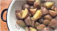  ?? JAN UEBELHLERR ?? Red-skinned potatoes are cut into bite-size pieces before cooking.