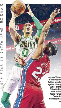  ??  ?? Jayson Tatum of the Boston Celtics shoots against Jimmy Butler of the Philadelph­ia 76ers at the Wells Fargo Center in Philadelph­ia.