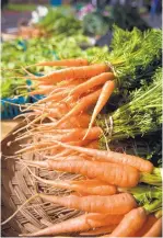  ??  ?? Corrales Chile Co. sells nantes carrots at the Los Ranchos Growers’ Market.