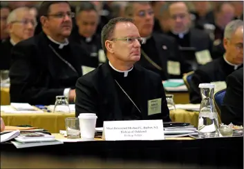  ??  ?? In this 2013 file photo, Roman Catholic Diocese of Oakland Bishop Michael Barber, center, listens to a presentati­on alongside fellow bishops at the United States Conference of Catholic Bishops’ annual fall meeting in Baltimore.