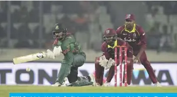  ??  ?? DHAKA: Bangladesh cricketer Liton Das (L) plays a shot as the West Indies cricketer Shai Hope (C) and Darren Bravo (R) looks on during the first One Day Internatio­nal (ODI) between Bangladesh and West Indies at the Shere-Bangla National Cricket Stadium in Dhaka yesterday. — AFP