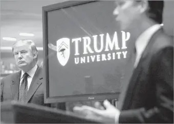  ?? Bebeto Matthews Associated Press ?? DONALD TRUMP, left, listens as Michael Sexton introduces him at a 2005 news conference in New York at which he announced the establishm­ent of Trump University.