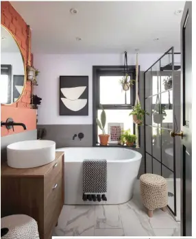  ??  ?? The family bathroom has been given a modernindu­strial look, with a free-standing bath and walk-in shower enclosure. The Crittall-style shower screen, from Bathstore, ties in with the matt black fixtures and fittings
