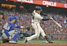  ?? AP photo ?? San Francisco Giants’ Buster Posey hits a double against Los Angeles Dodgers during the first inning of Game 5 of the National League Division Series Thursday, in San Francisco.