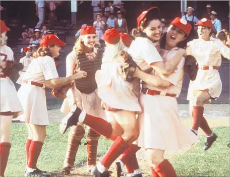  ?? Louis Goldman Columbia Pictures ?? GEENA DAVIS played catcher in “A League of Their Own” 25 years ago with Madonna, front left, and Rosie O’Donnell, front right.