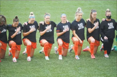  ?? Rick Bowmer / Associated Press ?? Players for the Houston Dash take a knee for the national anthem prior to their game against the Utah Royals FC.