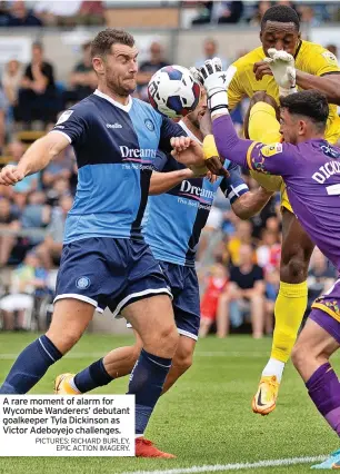  ?? PICTURES: RICHARD BURLEY, EPIC ACTION IMAGERY. ?? A rare moment of alarm for Wycombe Wanderers’ debutant goalkeeper Tyla Dickinson as Victor Adeboyejo challenges.