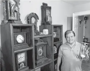  ?? DAVID MACDONALD • SPECIAL TO THE GUARDIAN ?? Alberto Cardona, a resident of Stratford, P.E.I., displays a small selection of his vintage clock collection, which numbers up to 150 items of virtually every era and design. Cardona purchased many of his clocks at yard sales across the province. But while he enjoys vintage clocks in particular, Cardona also enjoys the yard sale culture, which encompasse­s everything from meeting old and new friends to learning about the history and background of the items on sale and the people who sell them.