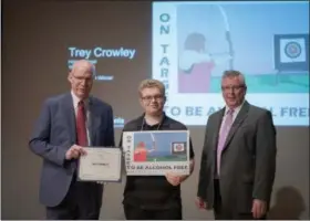  ?? SUBMITTED PHOTO ?? Second Place Grade Winner Trey Crowley, Grade 10, home schooled, with Pennsylvan­ia Liquor Control Board Chairman Tim Holden, left, and Executive Director Charlie Mooney, right.