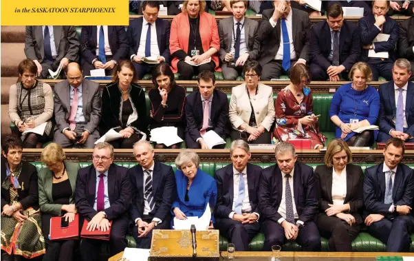  ?? JESSICA TAYLOR / UK PARLIAMENT / AFP / GETTY IMAGES ?? Britain’s Prime Minister Theresa May, centre, and members of Parliament listen as opposition leader Jeremy Corbyn speaks on Wednesday ahead of a no-confidence vote. May won the vote despite a crushing defeat on Tuesday over her Brexit deal that triggered warnings of a chaotic “no-deal” divorce.