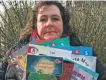  ?? ?? Alison Craig, who is chairperso­n of Comann nam Pàrant an Òbain, with just a few of the Gaelic books salvaged from a skip outside a former education office in Dalintart Drive.