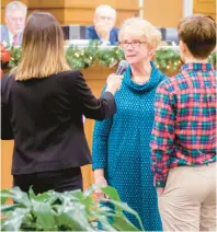  ?? CORINNE SAUNDERS/STAFF ?? Bea Basnight, center, is sworn in as a Dare County commission­er, taking the seat of Jim Tobin for the next year.