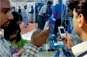  ?? AP ?? The ICT-mobile phones and the financial sector have decided to expand banking to benefit a larger number of customers. —