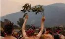  ?? Photograph: Rachel Mounsey/ The Guardian ?? Yuin people gather at Gulaga mountain in early December as smoke clouds the sky, to perform a ceremony to heal the country. Fires swept through the region over the new year period.