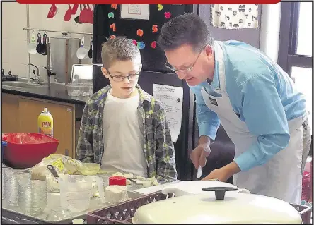  ??  ?? Todd Willis teaches Calvin Barley how to make “Monkey Bread” with “Monkey Fractions” in Willis’ third-grade classroom at Pleasant Hill Elementary School.
RAINA HANNA/SPECIAL TO DESOTO APPEAL
