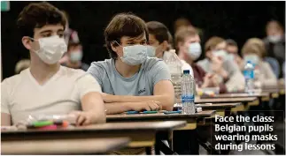  ??  ?? Face the class: Belgian pupils wearing masks during lessons