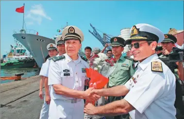  ?? YU WEI / XINHUA ?? Rear Admiral Shen Hao, the PLA Navy deputy commander of the East Sea Fleet, is greeted by Zaka-Ur-Rehman, a commodore of the Pakistani navy’s destroyer fleet on Saturday, when the Chinese fleet arrived at Karachi, Pakistan, for a four-day friendly...