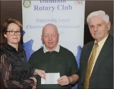  ??  ?? Críona O’Reilly and Gay Berkery, Dundalk Rotary Club make a presentati­on to Seamus Casey, Dundalk Stroke Group at a presentati­on by the Rotary Club to local groups.