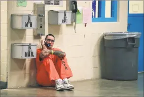  ?? Julie Jacobson / Associated Press file photo ?? Inmate Lance Shaver talks on the phone at the Albany County Correction­al Facility in 2017. Connecticu­t is considerin­g legislatio­n that would make phone calls from prison free to inmates.