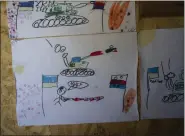  ?? ?? Drawings made by Ukrainian children decorate a sleeping area in a Ukrainian trench near the frontline on Wednesday.