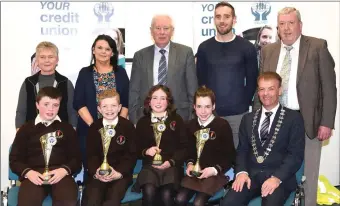  ??  ?? John Long Chairman Chapter 23 Credit Union (seated right) who presented 3rd prizes in the Chapter 23 Under 13 Schools Quiz to Shane O’Sullivan, Oisin Dineen, Aoibh Kelly and Hannah Ryan of Lissivigee­n National School Killarney with (back) Abina...