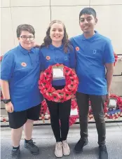  ??  ?? From left, Laurence Whittingha­m, Rhea Kellar and Minazur Rahman, who laid the school wreath at the Last Post ceremony