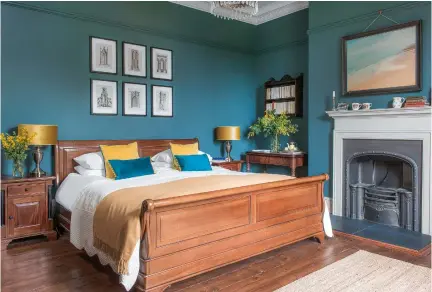  ??  ?? MAIN BEDROOM:
The deep wall colour was chosen to complement the richness of the wood pieces. Walls in Inchyra Blue estate emulsion, £49.50 for 2.5ltr, Farrow & Ball