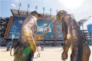  ?? MATT SLOCUM/ASSOCIATED PRESS ?? A 9-foot bronze statue depicting Philadelph­ia Eagles quarterbac­k Nick Foles, right, and head coach Doug Pederson discussing the “Philly Special” trick play in the Super Bowl is seen outside Lincoln Financial Field on Wednesday.