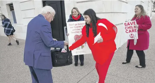  ?? ?? Activists offer Sen. Roger Wicker, R-Miss., a Valentine’s Day greeting while asking him to support expansion of the child tax credit on Feb. 8 in Washington, D.C.