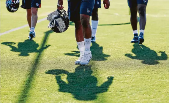  ?? Photos by Brett Coomer / Staff photograph­er ?? Texans players hope to cast a tall shadow with their performanc­e this season. Step one to that end will be excelling during camp at the Methodist Training Center.