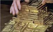  ?? PHOTO: AP ?? Spot gold was down 0.2 percent at $1 326.70 an ounce on Friday. It was down more than 1 percent for the week.