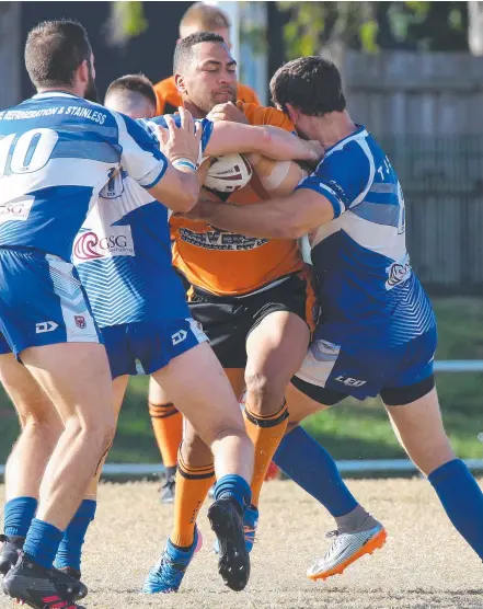  ?? Picture: MIKE BATTERHAM ?? Southport’s Sione Atu battles his way past a couple of Tugun defenders.