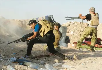  ?? AP ?? Iraqi security forces face an Islamic State group attack in Husaybah, Iraq, in July 2015. Four years after being vanquished in Syria, the extremist group has carried out its most deadly attacks in the country since early in 2022, targeting truffle hunters.