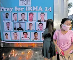  ?? —RICHARD A. REYES ?? PRAYER VIGIL FOR IRMA 14 Families of the 14 missing victims of the collision light candles during a prayer vigil at the company premises in Malabon on Wednesday.