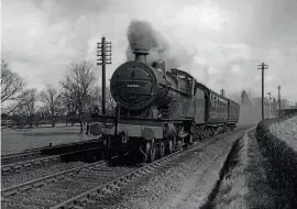  ??  ?? Compound 4-4-0 No. 1159 heads a Stafford-Shrewsbury express over the GWR/ LMS joint line near Admaston with a through Euston-Swansea coach on February 13, 1945. MORTONS RAILWAY MAGAZINE ARCHIVE/AS WILSONJONES.
