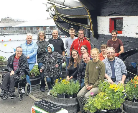  ??  ?? GREEN-fingered staff and volunteers from Dundee’s HM Frigate Unicorn joined forces with the Dundee Inclusion Group under the name The Unicorn Gardeners to breathe new life into the vessel’s Victoria Dock mooring.
The Unicorn Gardeners are working...