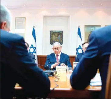  ?? SEBASTIAN SCHEINER/AFP ?? Israeli Prime Minister Benjamin Netanyahu (centre) chairs the weekly cabinet meeting at his office in Jerusalem on Sunday.