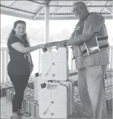  ??  ?? Managing Director of GWI, Dr. Richard Van WestCharle­s (right) symbolical­ly presents the Jerrycans to Councillor, Marcie Fredericks. (GWI photo)